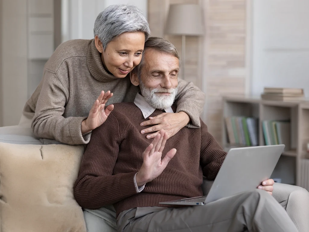 Senior couple using laptop together
