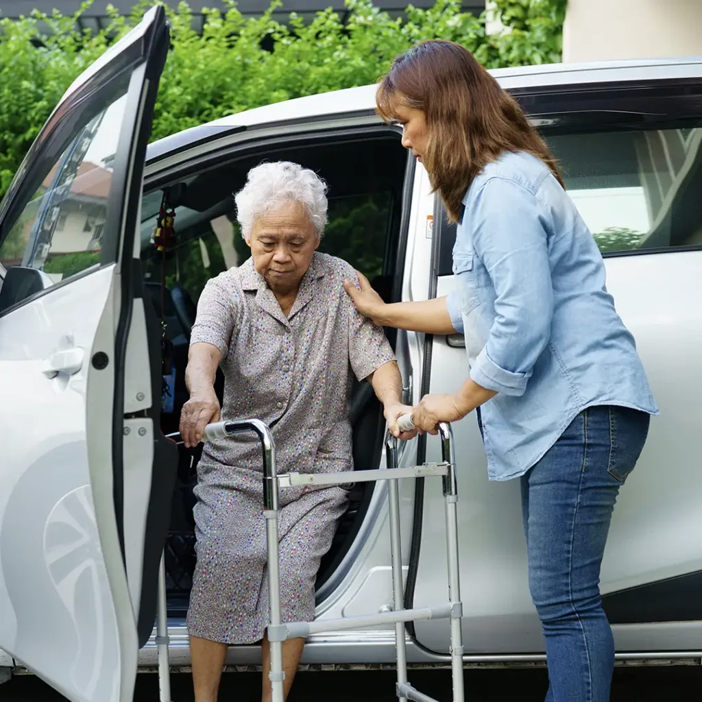 Assisting elderly woman out of her vehicle