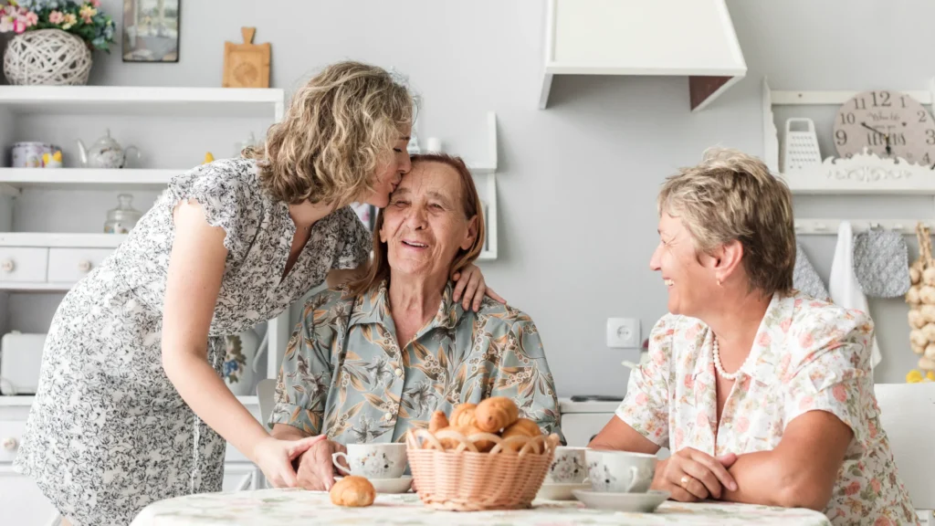 Family enjoying breakfast around a kitchen table, showing how at home care services help seniors stay independent